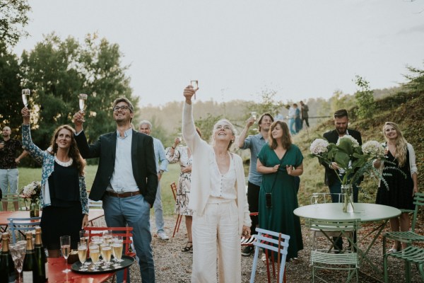 Guests cheers to couple on balcony