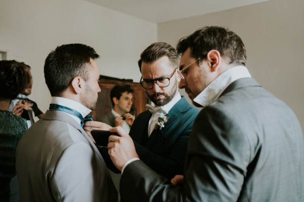 Groomsman groom getting ready fixing shirt and ties