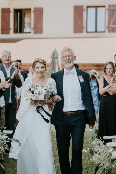 Father of the bride walks down the aisle towards alter