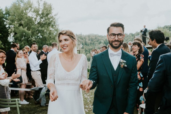 Bride and groom confetti being thrown over couple and guests