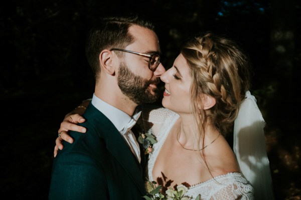 Dark photography of couple smiling bride and groom embrace