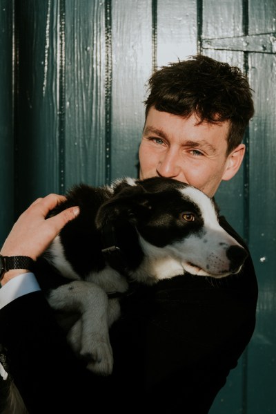 Man kissing dog on head