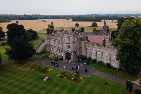 Drone footage of wedding venue and guests outside