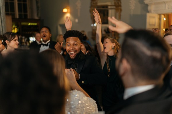 Groom bride and guests dance on the dancefloor