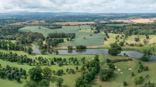 Drone footage of castle gardens and lake