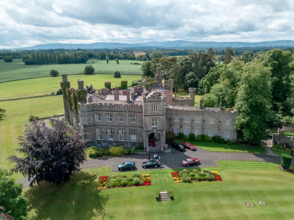 Drone footage of castle gardens parked cars