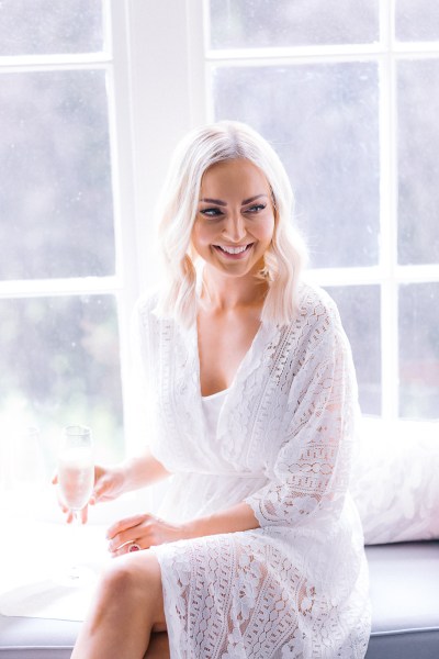 Smiling bride with glass of champagne/prosecco