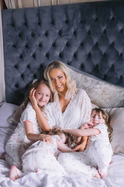 Bride and her two daughters two little girls in bed