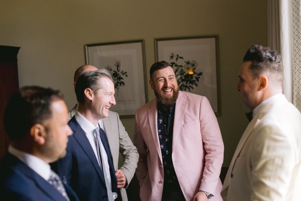 Groom and groomsmen smiling laughing