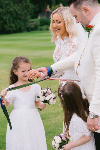 Bride and groom are bound with ribbon