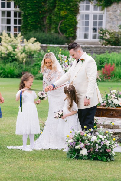 Bride groom and children get to cut the ribbon