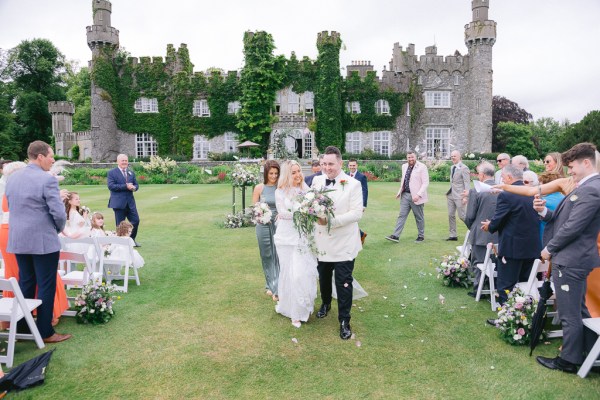 Bride and groom exit the ceremony pronounced husband and wife confetti guests clapping