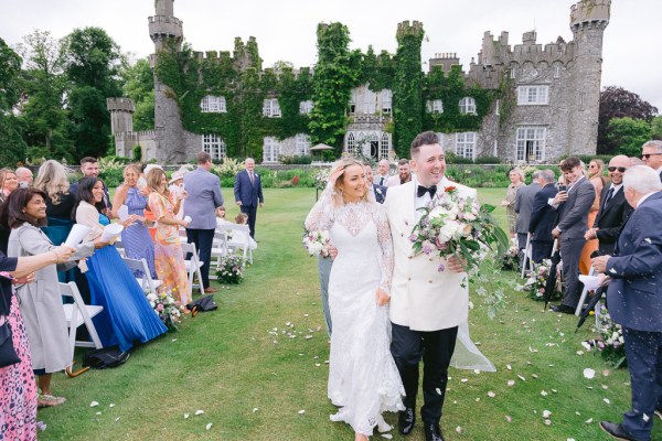 Bride and groom exit the ceremony pronounced husband and wife confetti guests clapping