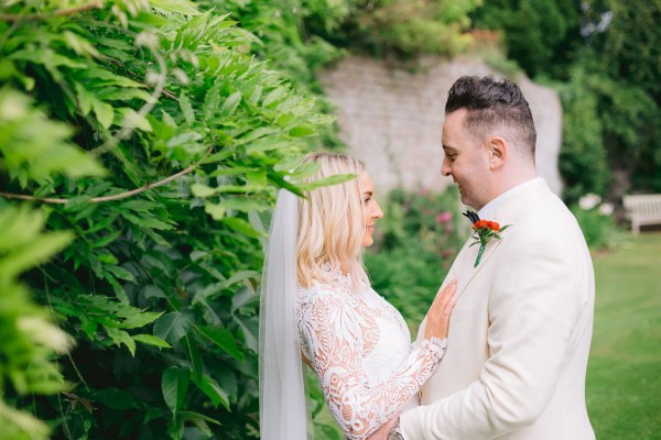 Bride and groom smiling in garden together