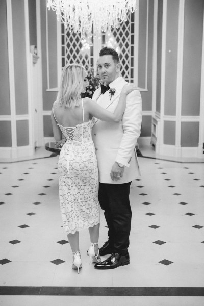 Black and white bride and groom dancing on tiles