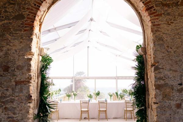 Empty ceremonial dining room table and chairs archway