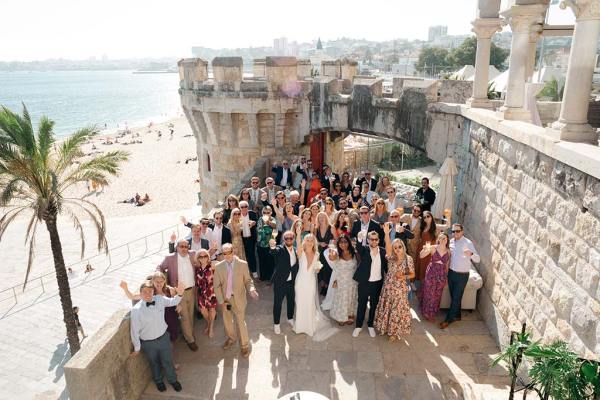 Group photo of bride groom family members waving cheering