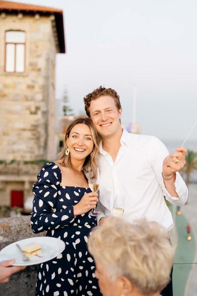 Man in white shirt with woman pose for a photo