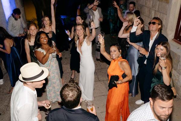 Woman wearing orange dress and bride dance