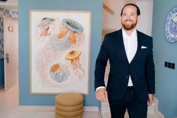 Groom is ready standing beside portrait in room