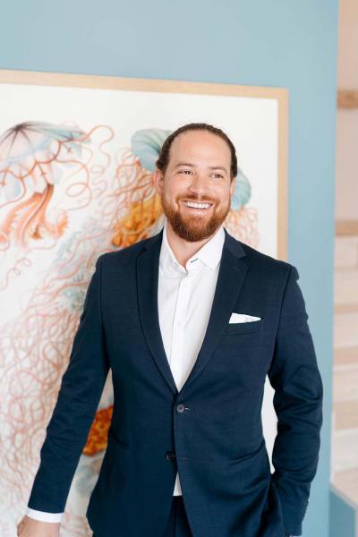 Groom is ready standing beside portrait in room