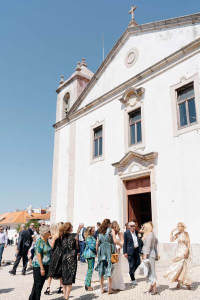 Wedding venue exterior church guests standing in the sun