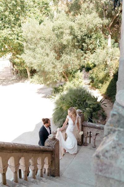 Bride and groom make their way up the steps stairs