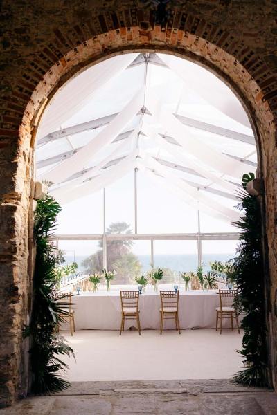 Empty ceremonial dining room table and chairs archway