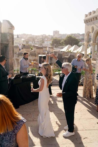 Bride with family members and guests holding glass of champagne