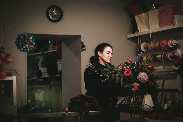 Woman fixing up bouquet flowers