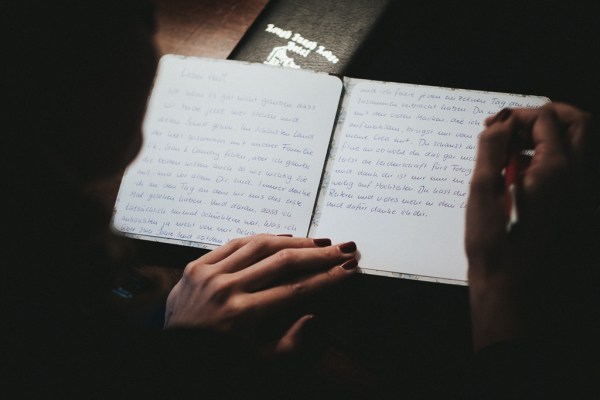 Bride writes down her vows for ceremony pen and paper