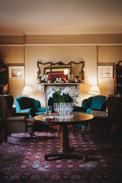 Empty manor house room with empty glasses of champagne