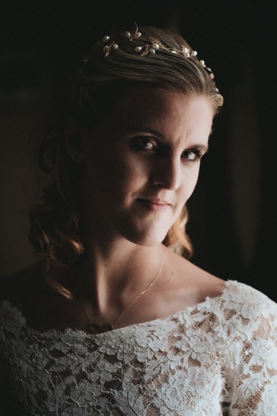 Bride looks at camera dark photography