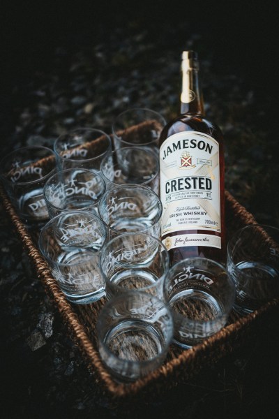 Bottle of Jameson Whisky and glasses stacked