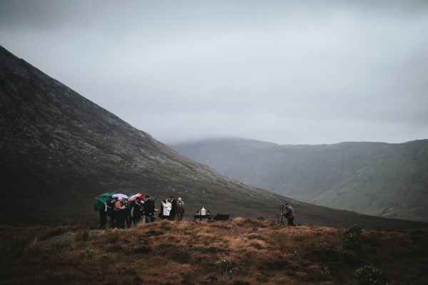 Line of guests heading to ceremony spot on cliff