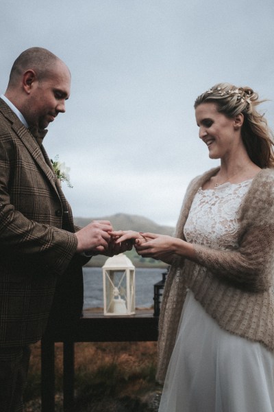 Groom puts ring on bride