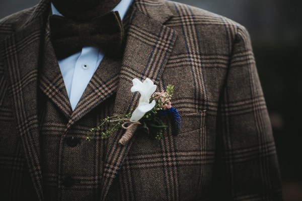 Close up of grooms tweed jacket and flower brooch