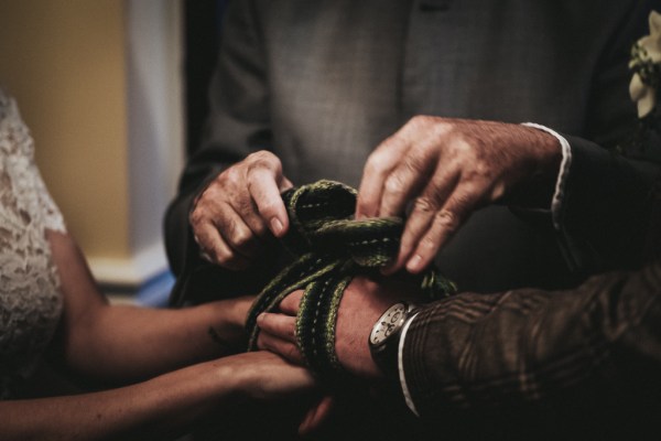 Couple being bound with written by celebrant bride and groom alter