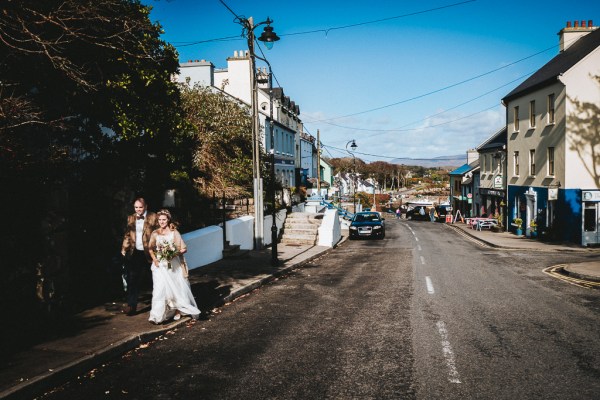 Brid and groom walking along pathway to main road