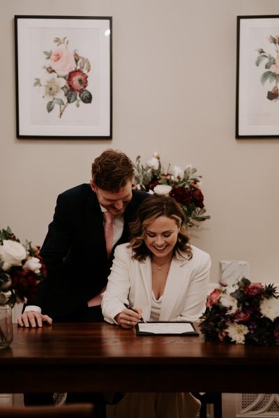 Bride and groom signing the marriage certificate