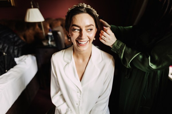 Bride sits as she gets ready