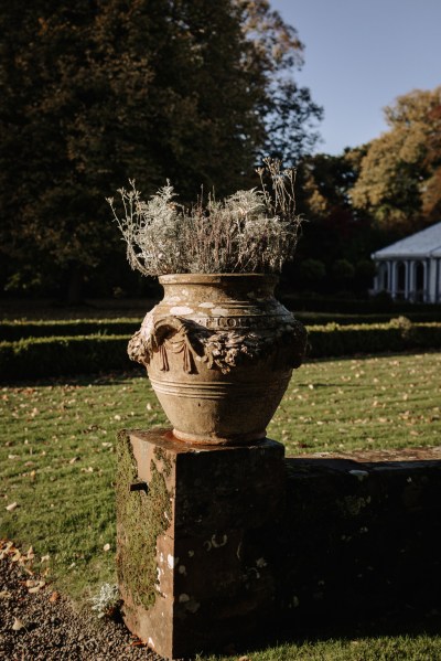 Statue containing flowers in garden