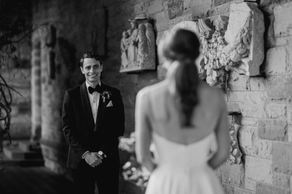 Groom sees bride and gets emotional black and white image