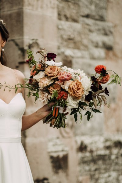 Close up of brides bouquet containing flowers and roses