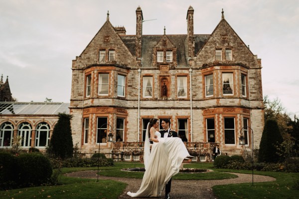 Groom picks up bride in front of wedding venue exterior