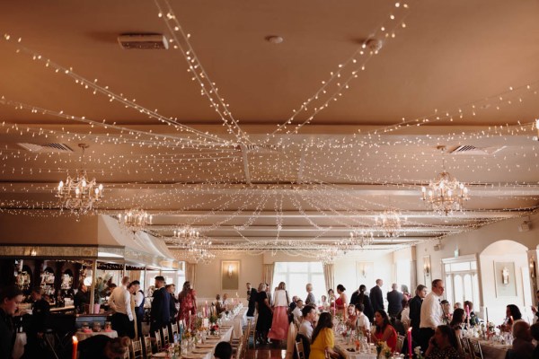 Guests seated at dining room table wide shot