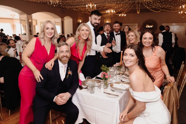 Bride groom guests pose for a photo