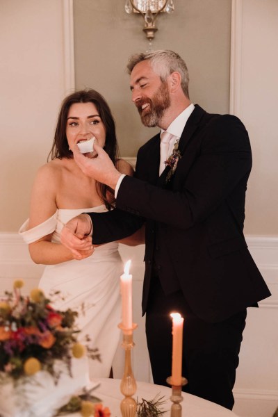 Bride and groom enjoying the wedding cake after cutting it