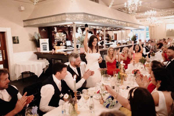 Bride groom and guests at dining room table