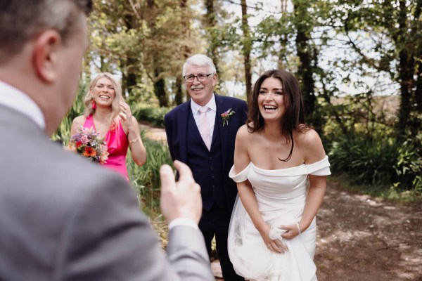 Father and bride gesture to family members